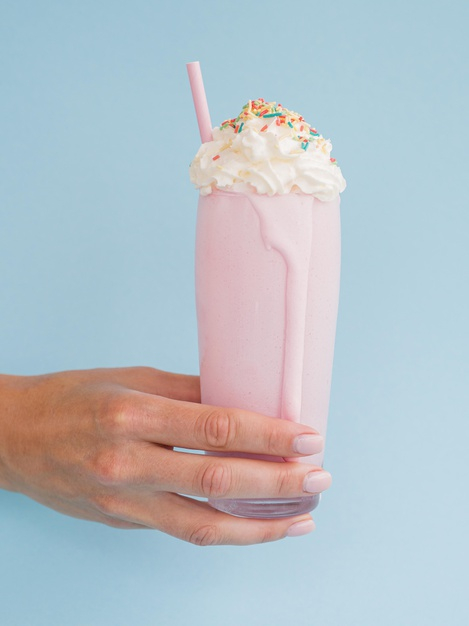 Milk-shake rose sur fond bleu